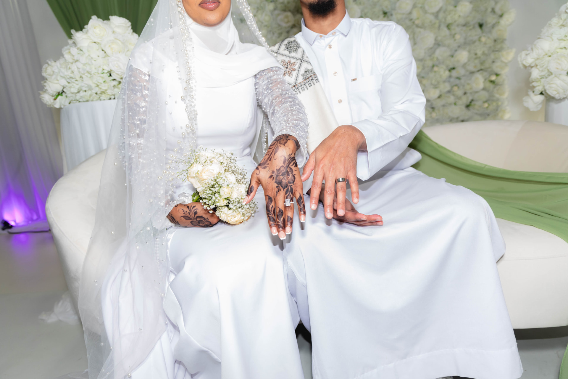 Bride and groom in white attire with henna details at a St. Cloud wedding
