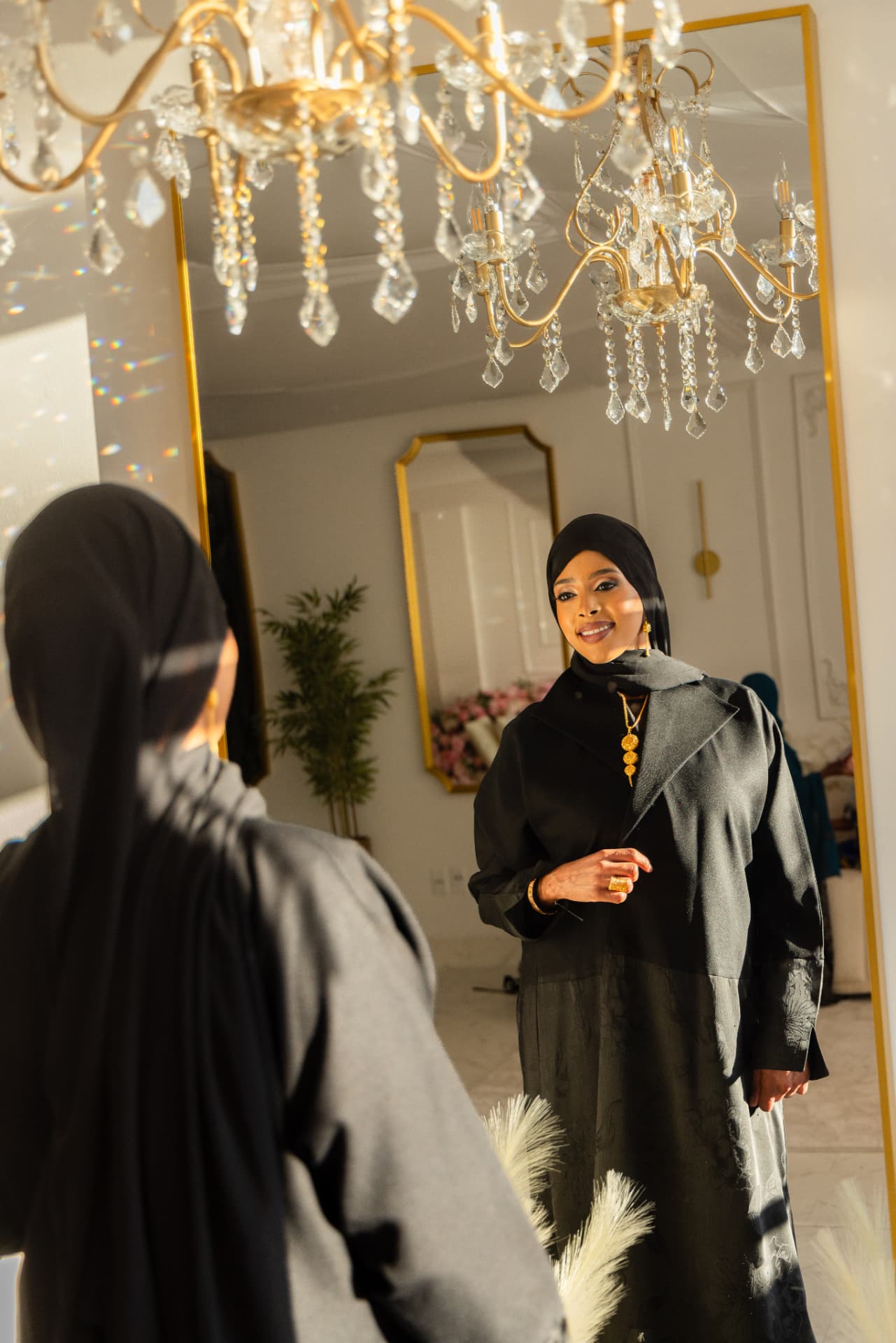 Mirror portrait under a crystal chandelier in the Xirfad Studio